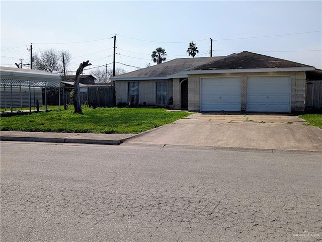 ranch-style home featuring a garage, a front lawn, and a carport