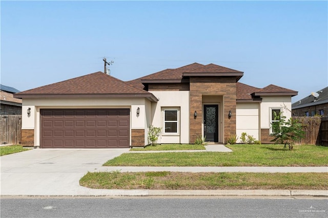 view of front of home with a garage and a front lawn