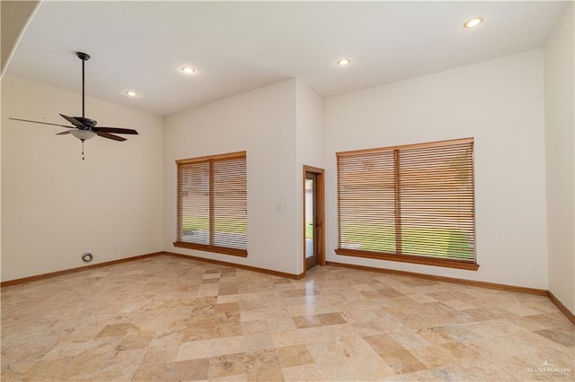 spare room featuring vaulted ceiling and ceiling fan