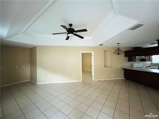 105 S Ridge Ln, San Juan, TX 78589 - unfurnished living room with a tray ceiling, light tile patterned floors, and ceiling fan