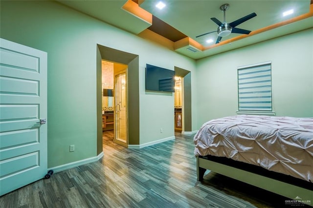 bedroom with ceiling fan, ensuite bathroom, and wood-type flooring