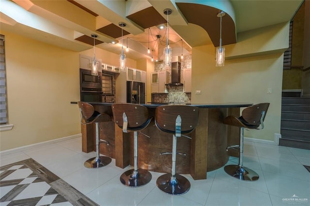 bar featuring wall chimney exhaust hood, built in microwave, decorative light fixtures, white cabinets, and black oven