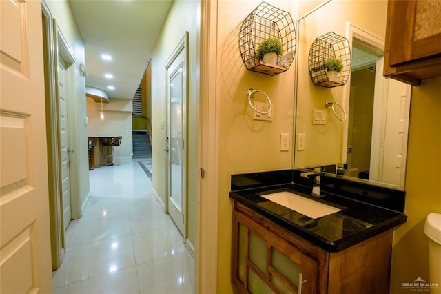 bathroom featuring tile patterned floors, vanity, and toilet