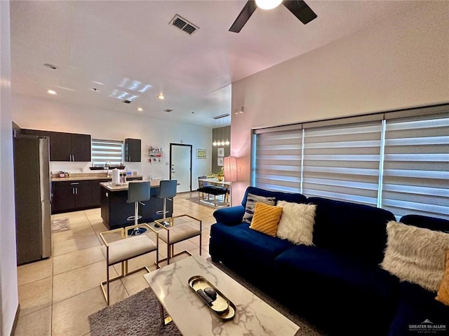 living room featuring ceiling fan and light tile patterned floors