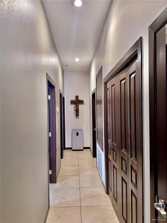 hallway featuring light tile patterned flooring