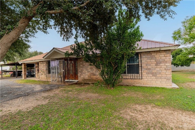 view of front facade with a front yard and a carport