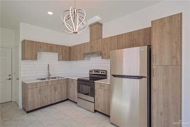 kitchen featuring backsplash, hanging light fixtures, sink, appliances with stainless steel finishes, and a chandelier