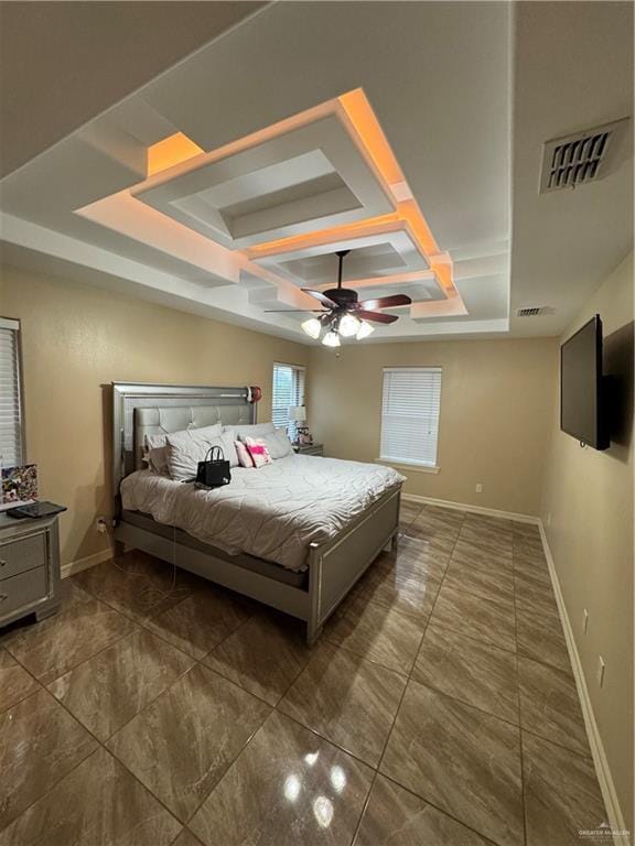 bedroom with coffered ceiling, a ceiling fan, visible vents, baseboards, and a raised ceiling