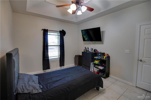 104 El Dora Rd, Alamo, TX 78516 - bedroom featuring a raised ceiling, light tile patterned floors, baseboards, and a ceiling fan