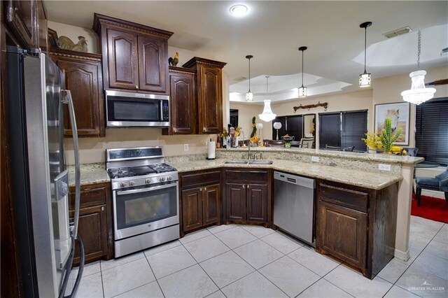 104 El Dora Rd, Alamo, TX 78516 - kitchen featuring stainless steel appliances, a sink, light tile patterned flooring, a peninsula, and dark brown cabinets