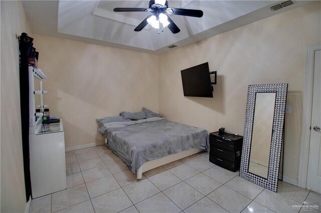 104 El Dora Rd, Alamo, TX 78516 - bedroom featuring a tray ceiling, light tile patterned floors, baseboards, and ceiling fan