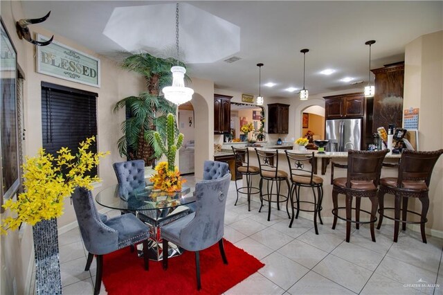 104 El Dora Rd, Alamo, TX 78516 - dining space with arched walkways, light tile patterned flooring, and baseboards