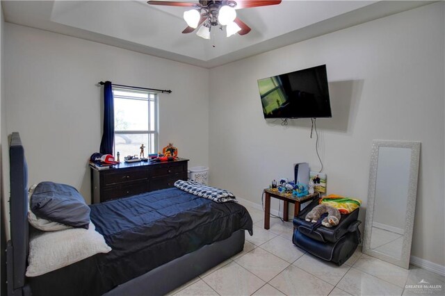 104 El Dora Rd, Alamo, TX 78516 - bedroom with light tile patterned floors, a raised ceiling, baseboards, and a ceiling fan