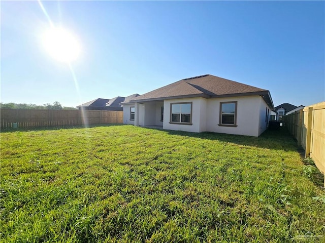 back of property featuring a lawn