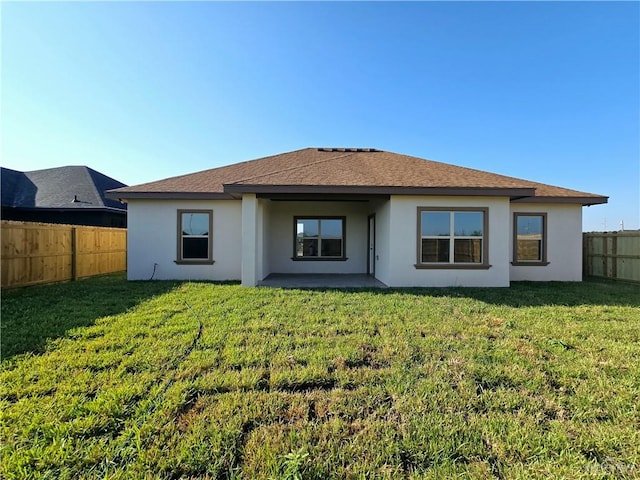 rear view of house with a patio area and a lawn