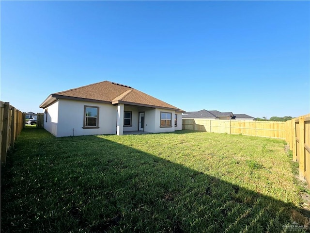 rear view of house with a yard