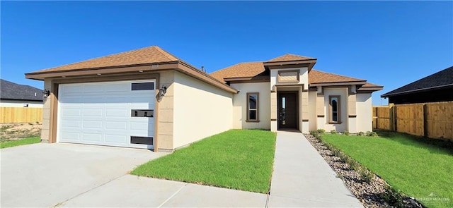 view of front of property with a front yard and a garage