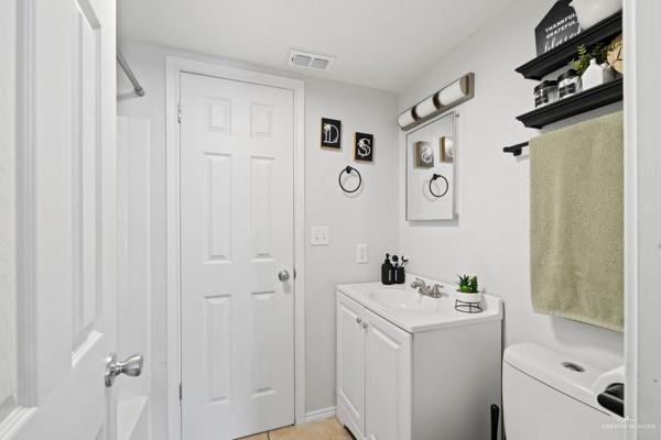 bathroom featuring vanity and toilet