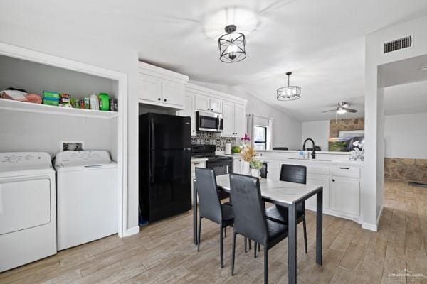 dining room with lofted ceiling, sink, ceiling fan, light hardwood / wood-style floors, and washing machine and dryer