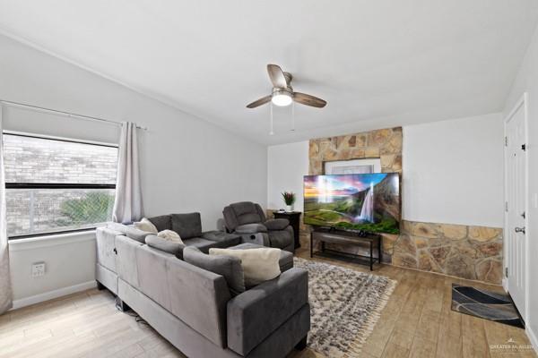 living room with ceiling fan and light hardwood / wood-style floors