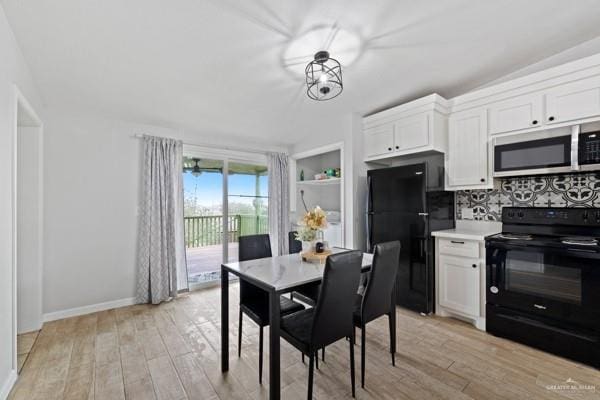 kitchen with white cabinetry, decorative backsplash, black appliances, and light wood-type flooring