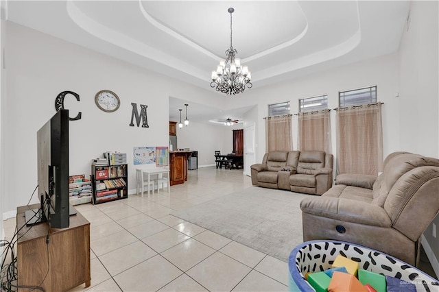 2103 W 30th St, Mission, TX 78574 - living room with a tray ceiling, a chandelier, light tile patterned floors, and ceiling fan