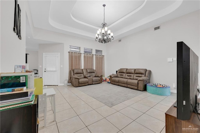 2103 W 30th St, Mission, TX 78574 - living room with a raised ceiling, light tile patterned floors, and a chandelier