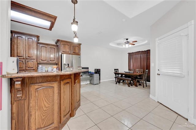 2103 W 30th St, Mission, TX 78574 - kitchen featuring stainless steel fridge with ice dispenser, light tile patterned floors, a ceiling fan, a peninsula, and hanging light fixtures
