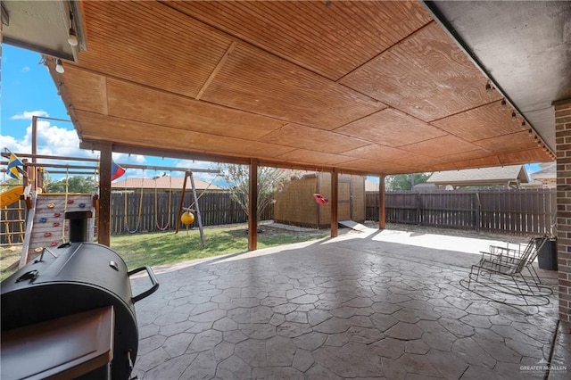 2103 W 30th St, Mission, TX 78574 - view of patio with a playground, a shed, an outdoor structure, and a carport