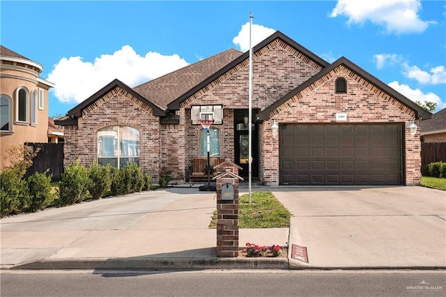 2103 W 30th St, Mission, TX 78574 - view of front of home with brick siding, concrete driveway, and an attached garage
