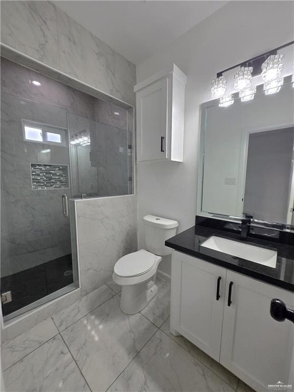 bathroom with vanity, toilet, and an enclosed shower