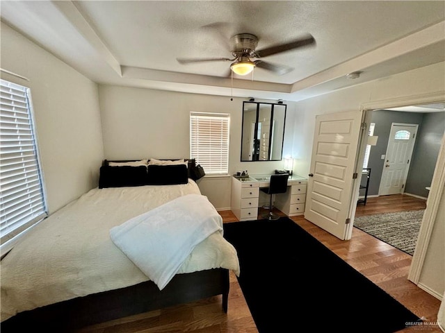 bedroom featuring multiple windows, light hardwood / wood-style flooring, and ceiling fan