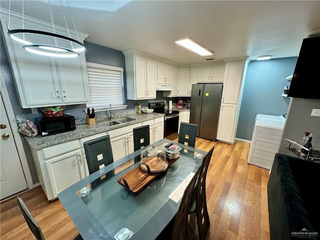 kitchen with sink, white cabinets, black appliances, and light wood-type flooring