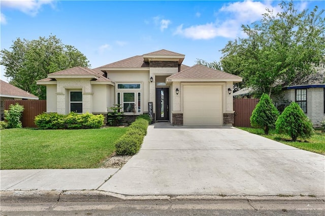 900 E Camelia Ave, Hidalgo, TX 78577 - prairie-style home featuring concrete driveway, stucco siding, a garage, and roof with shingles