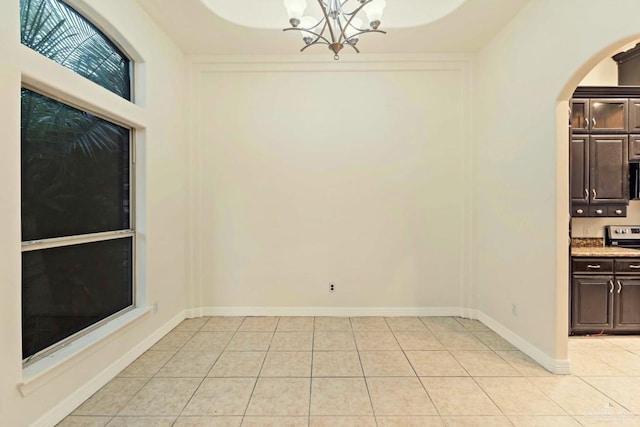 interior space with light tile patterned floors and a chandelier