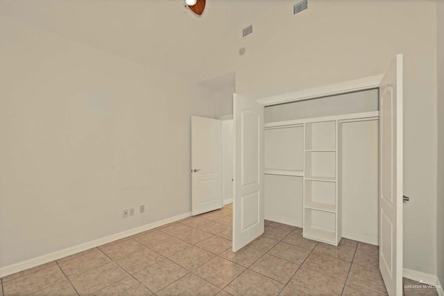 unfurnished bedroom featuring light tile patterned floors and a closet