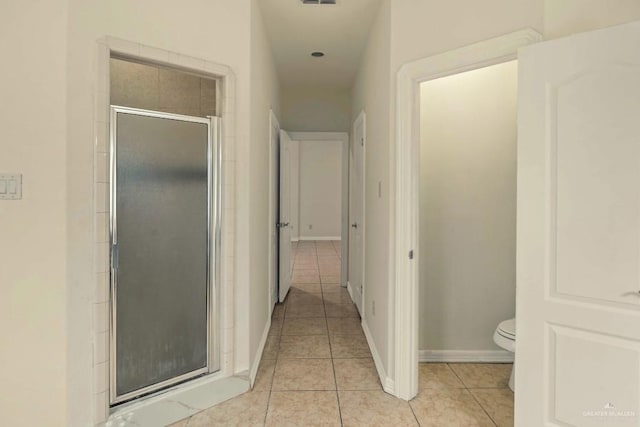 hallway featuring light tile patterned floors