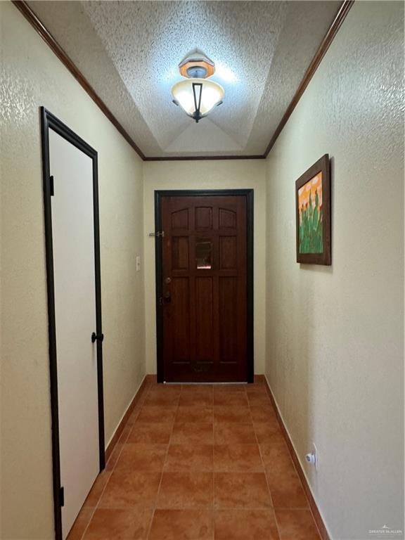 doorway to outside featuring tile patterned flooring, crown molding, and a textured ceiling