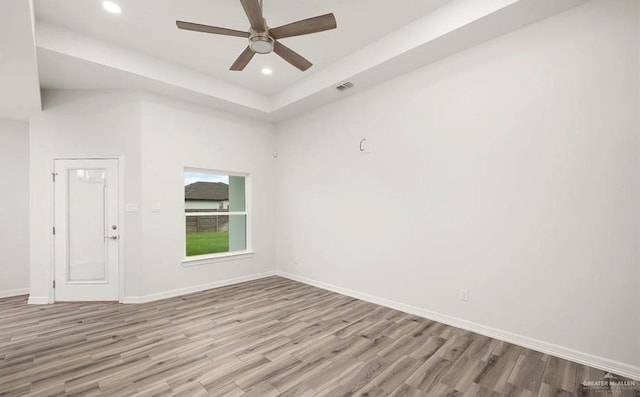 spare room with light wood-type flooring and ceiling fan