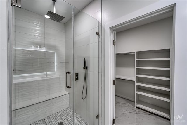 full bath featuring a spacious closet and a stall shower