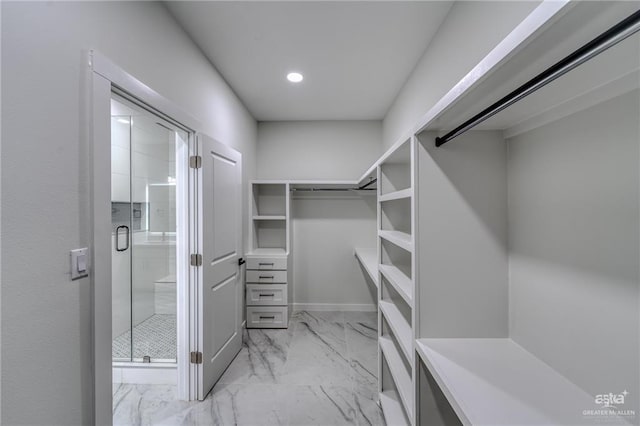 spacious closet featuring marble finish floor