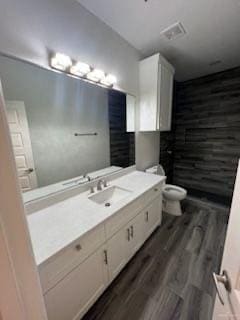 bathroom featuring hardwood / wood-style floors, vanity, and toilet