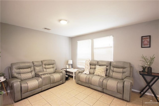 living area featuring light tile patterned floors and visible vents