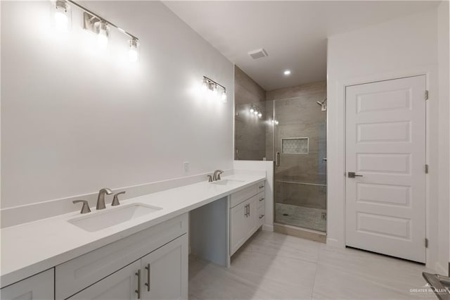 bathroom featuring double vanity, a sink, visible vents, and a shower stall