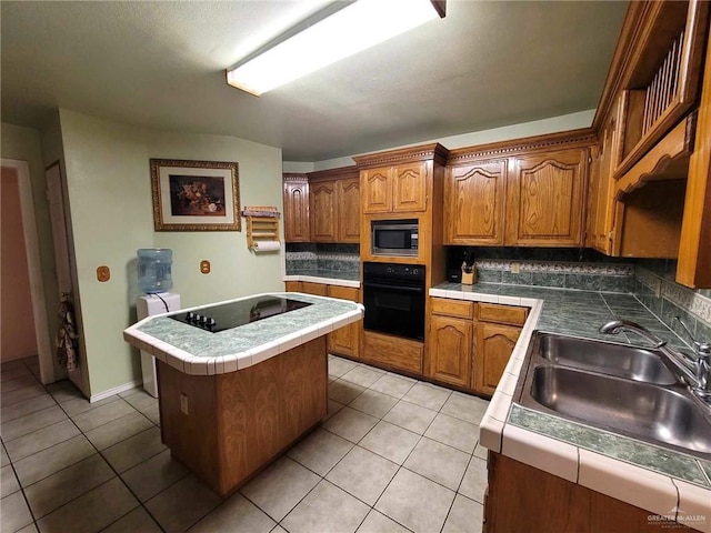 kitchen with sink, a center island, backsplash, light tile patterned floors, and black appliances