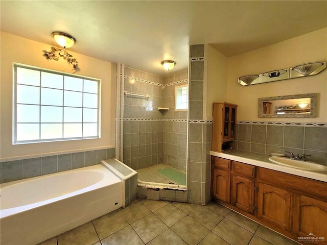 bathroom featuring tile patterned floors, vanity, and independent shower and bath