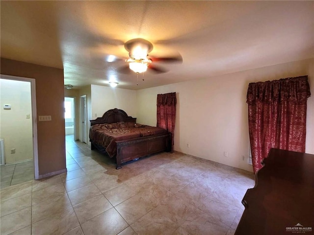 tiled bedroom featuring ceiling fan