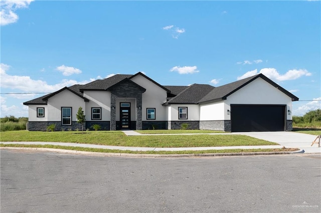 view of front of property featuring a garage and a front yard