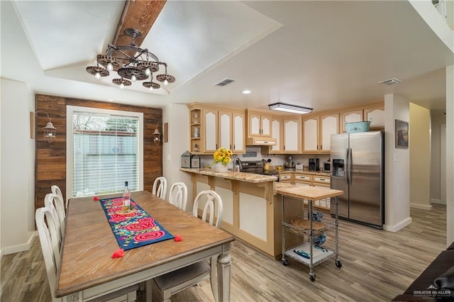 dining area featuring light hardwood / wood-style flooring and lofted ceiling