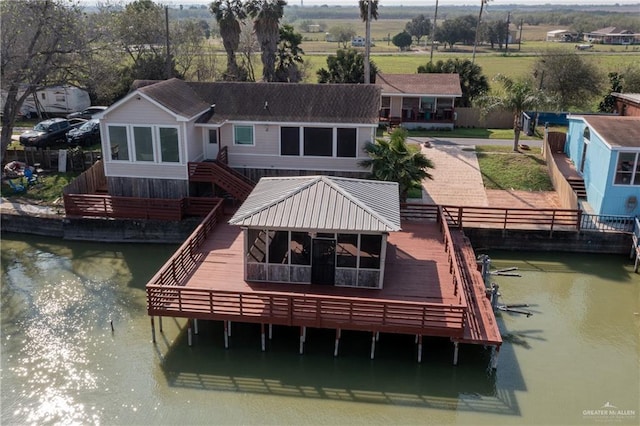 back of property with a deck with water view